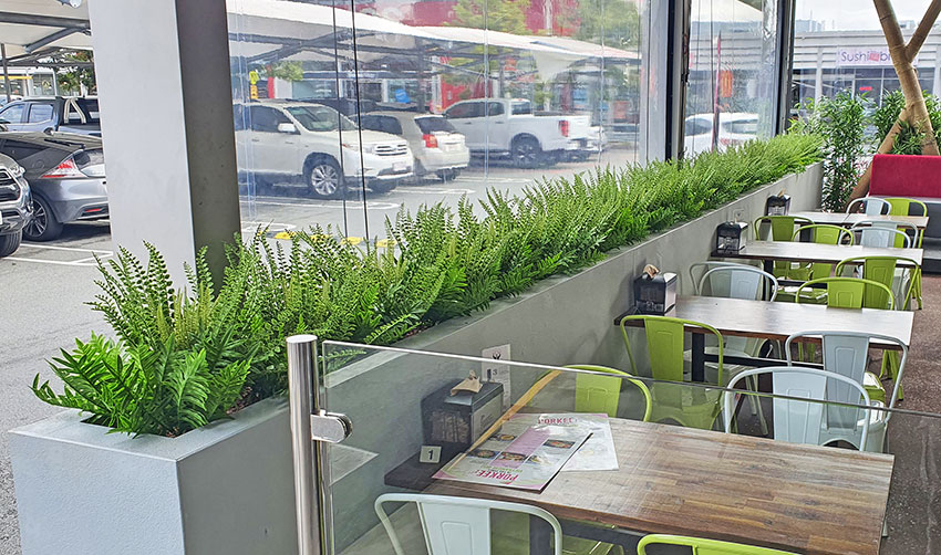 outdoor barrier planter in restaurant